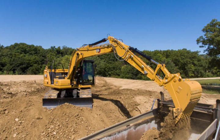 An excavator removing land mass from the construction site