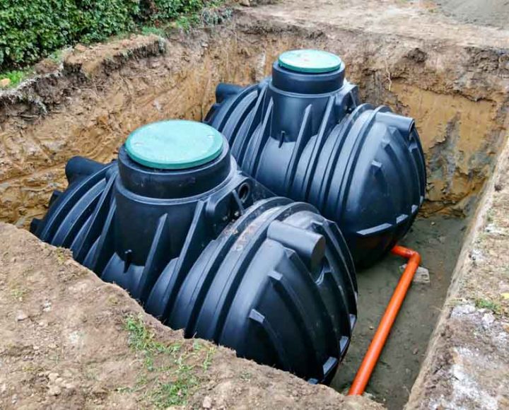 Two plastic underground storage tanks placed below ground for harvesting a rainwater.